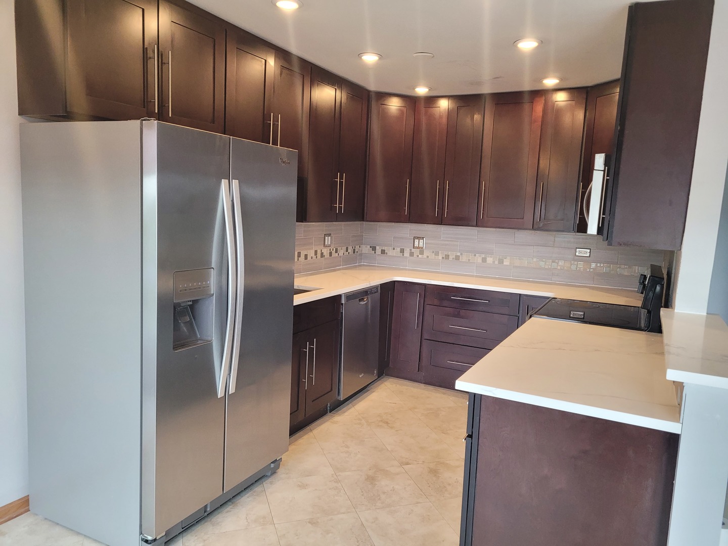 725 West Huntington Commons Road, Unit 208 Mount Prospect, IL 60056 - Photo 10 of 21 a kitchen with stainless steel appliances a refrigerator and a sink