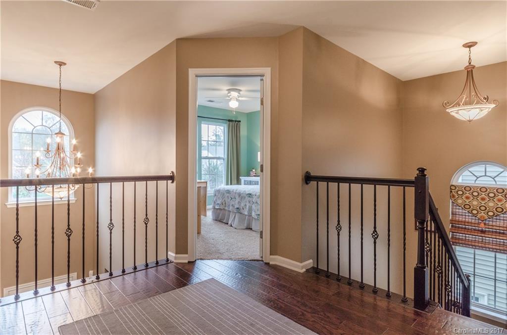 7191 Meyer Road Fort Mill, SC 29715 - Photo 14 of 24 a view of a hallway with wooden floor and stairs