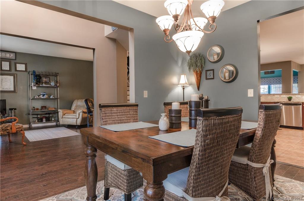 7191 Meyer Road Fort Mill, SC 29715 - Photo 3 of 24 a view of a dining room with furniture and wooden floor