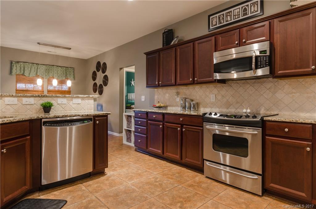 7191 Meyer Road Fort Mill, SC 29715 - Photo 9 of 24 a kitchen with stainless steel appliances granite countertop a stove a microwave and a sink