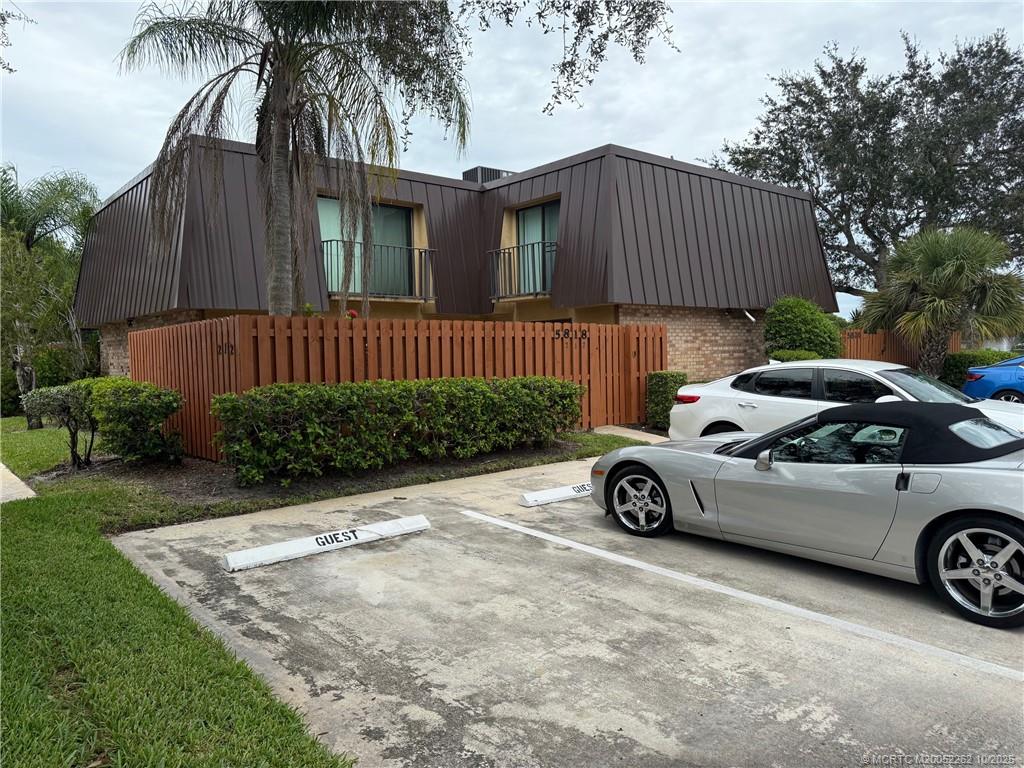 5818 Southeast Windsong Lane Stuart, FL 34997 - Photo 1 of 18 a car parked in front of a house