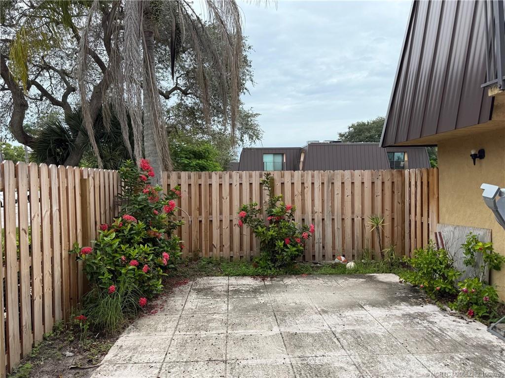 5818 Southeast Windsong Lane Stuart, FL 34997 - Photo 18 of 18 a garden with flowers in front of it