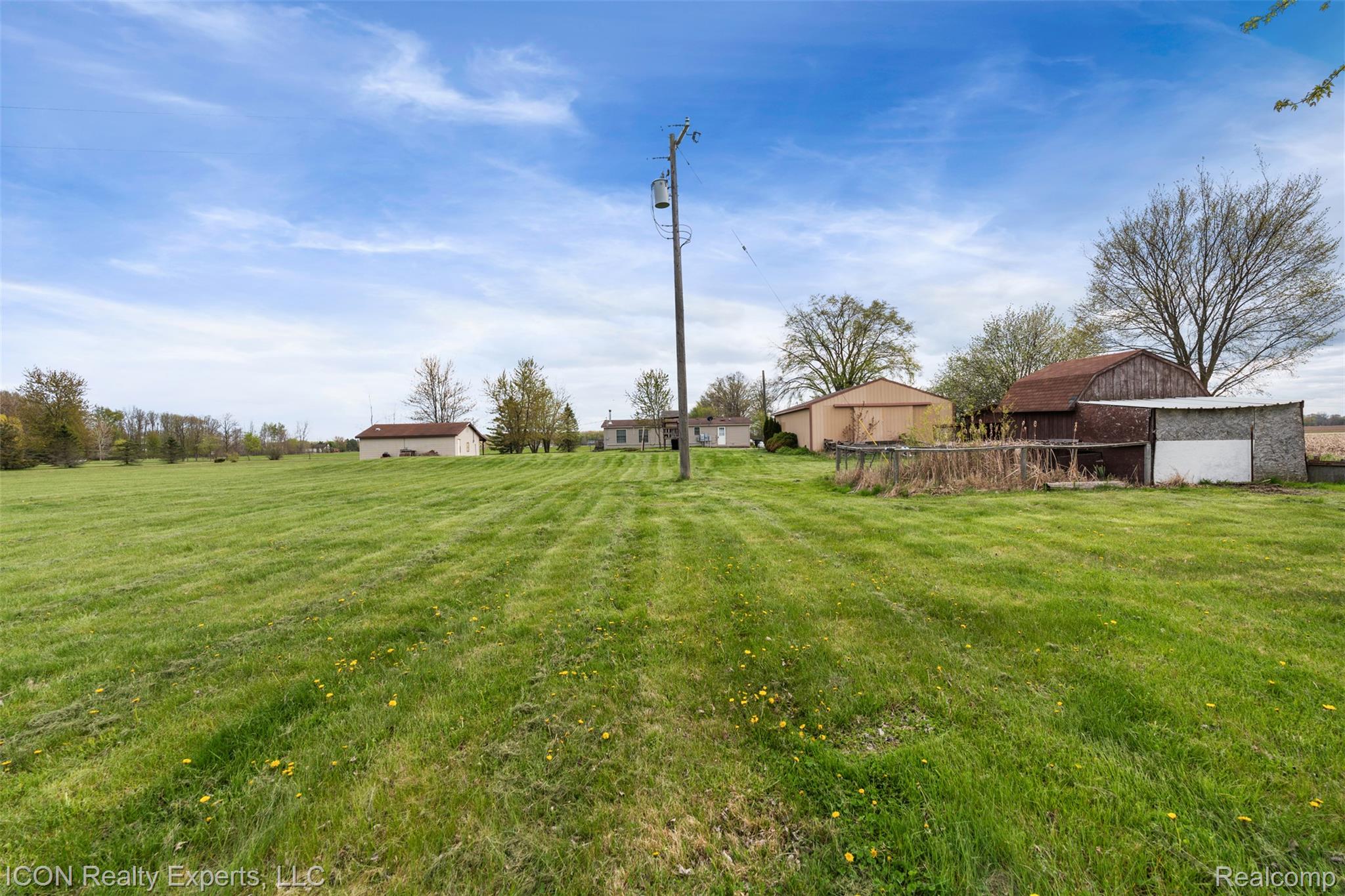 13620 Gilbert Road Allenton, MI 48002 - Photo 34 of 47 View of green lawn featuring an outdoor structure and a barn