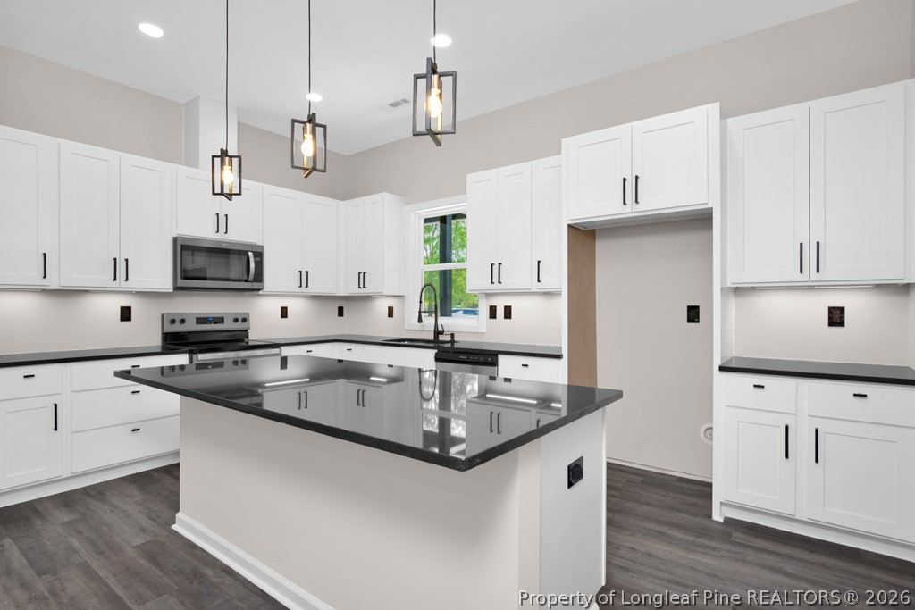 3025 Old Stage Road South Erwin, NC 28339 - Photo 14 of 50 a kitchen with stainless steel appliances granite countertop a sink a stove and a refrigerator