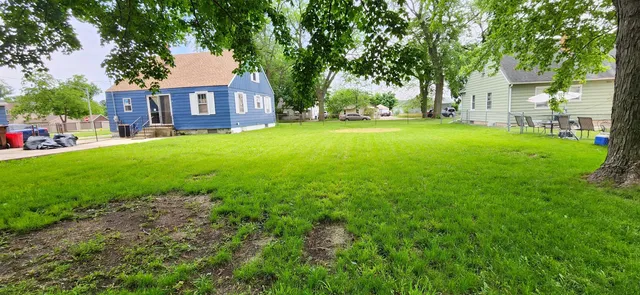 a view of house with yard and green space