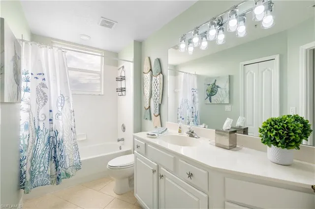 a bathroom with a double vanity sink mirror and shower