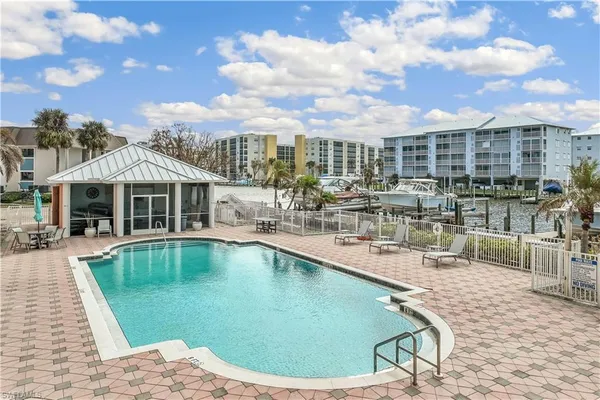 a view of a swimming pool with outdoor seating