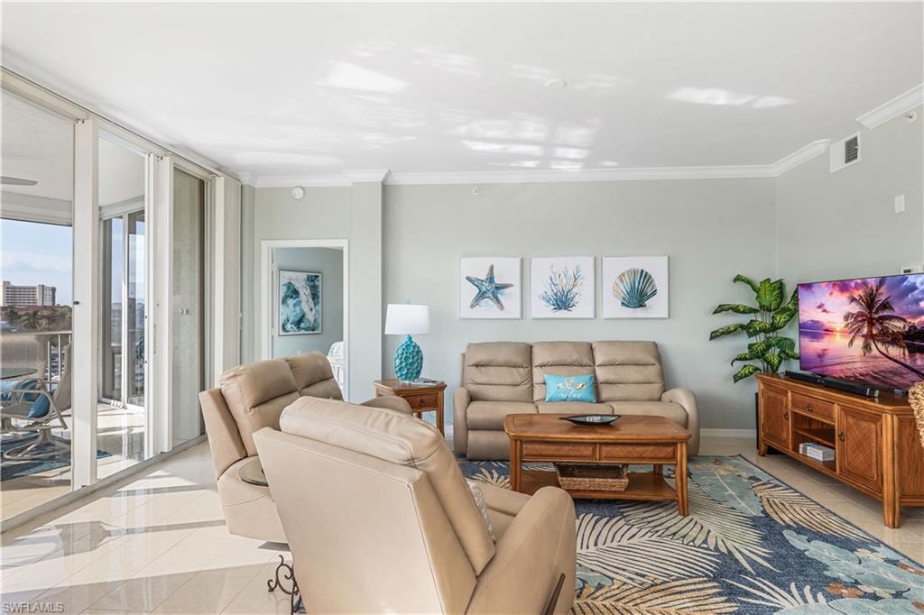 170 Lenell Road, Unit 401 Fort Myers Beach, FL 33931 - Photo 4 of 24 a living room with furniture and a fireplace