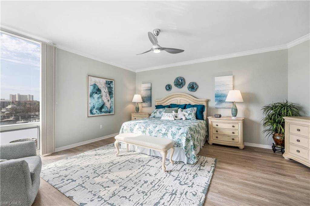 170 Lenell Road, Unit 401 Fort Myers Beach, FL 33931 - Photo 10 of 24 a bedroom with a bed and a chandelier