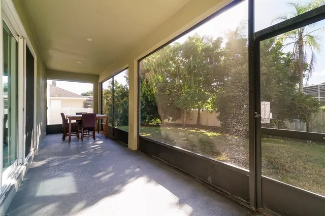 a view of a porch with chairs and backyard