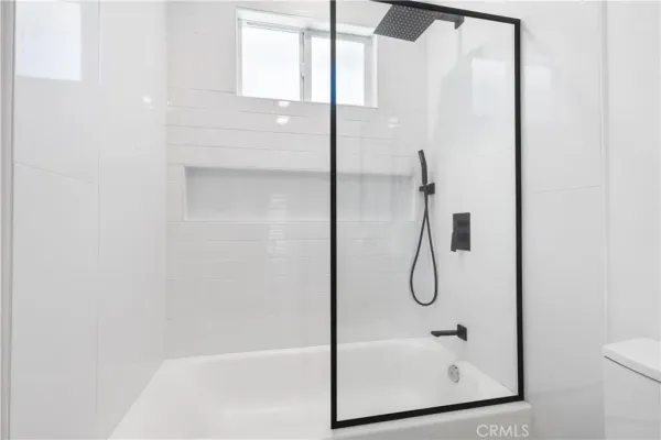 a bathroom with a glass shower door