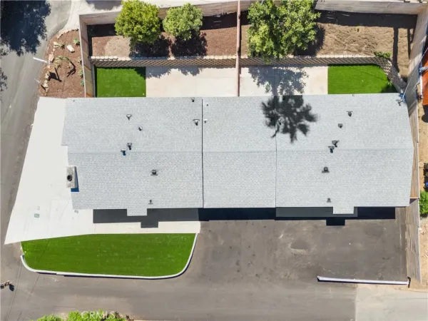 an aerial view of a house with a yard