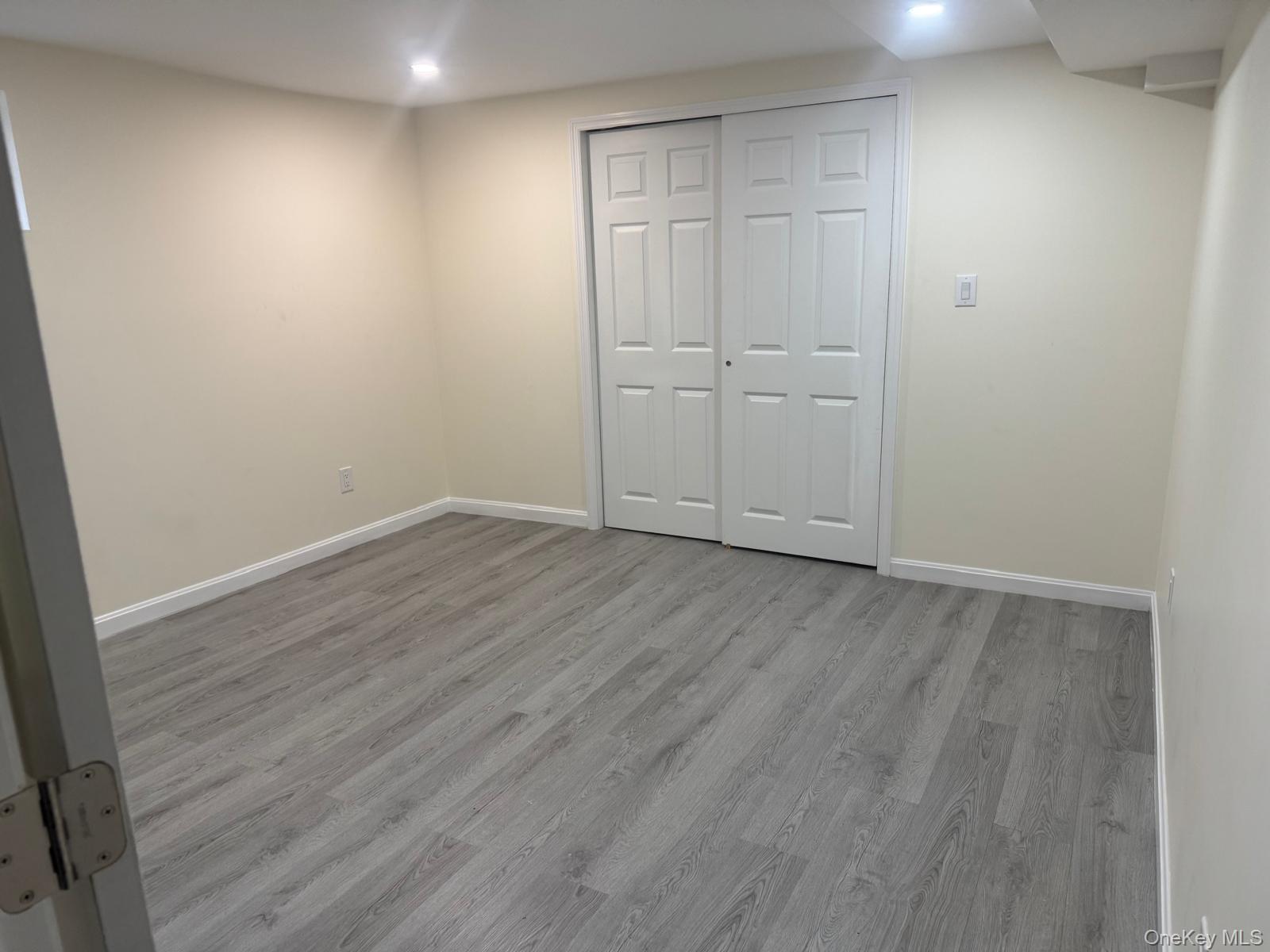 80-23 247th Street Queens, NY 11426 - Photo 15 of 19 a view of an empty room with wooden floor