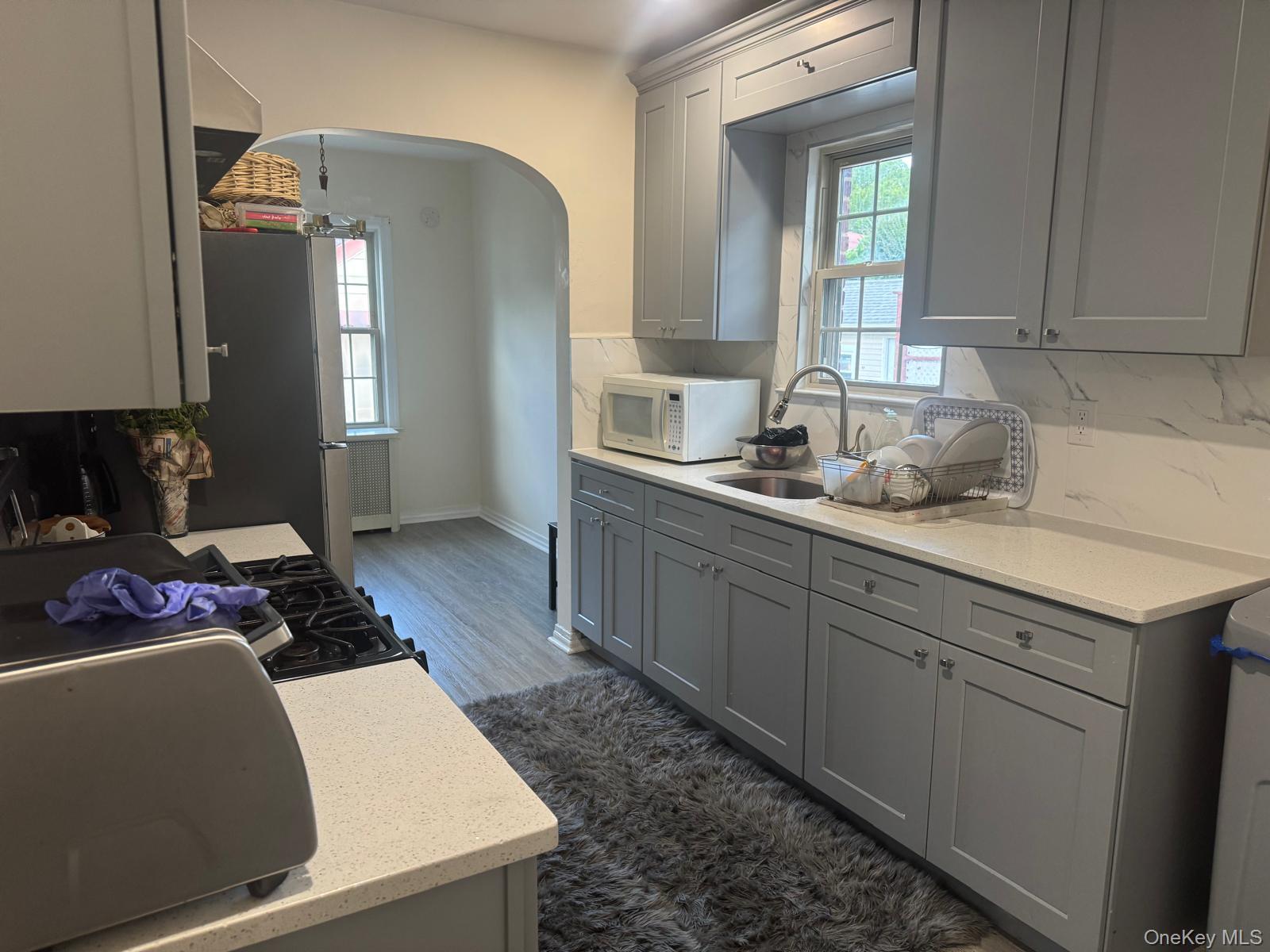 80-23 247th Street Queens, NY 11426 - Photo 16 of 19 a kitchen with a sink and cabinets