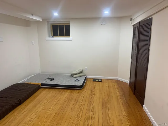 a view of a room with wooden floor and pool table