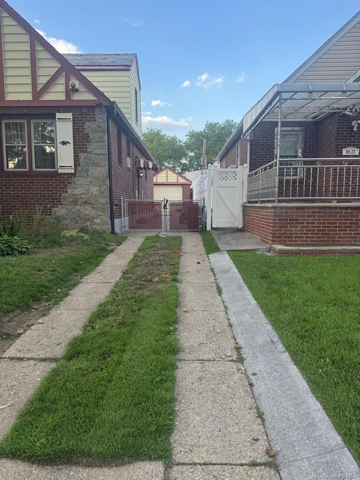 80-23 247th Street Queens, NY 11426 - Photo 18 of 19 a front view of a house with a yard
