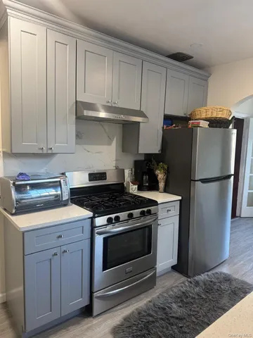 a kitchen with cabinets appliances and a sink