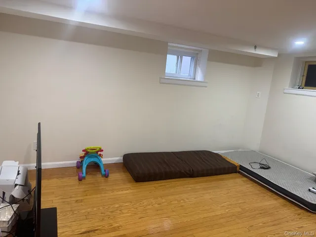 a view of a room with wooden floor and furniture