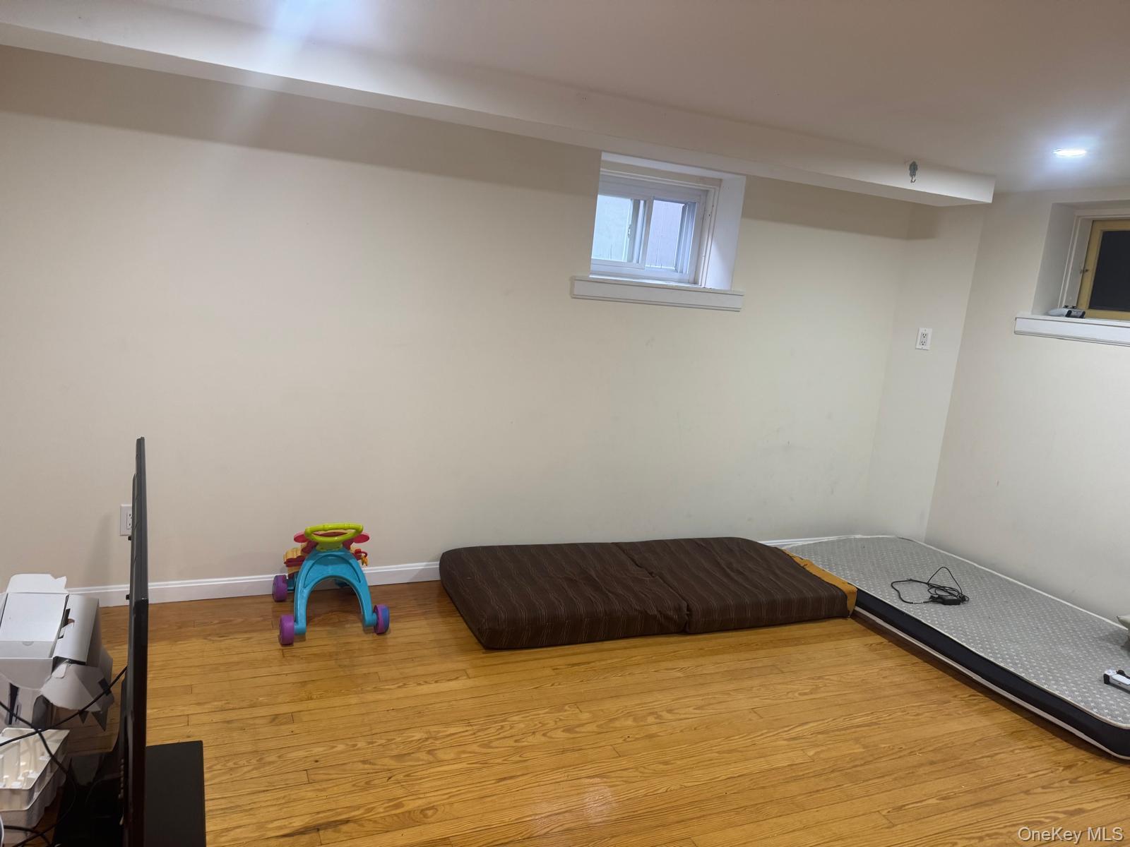 80-23 247th Street Queens, NY 11426 - Photo 6 of 19 a view of a room with wooden floor and furniture