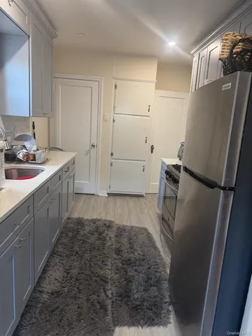 a kitchen with a sink and refrigerator