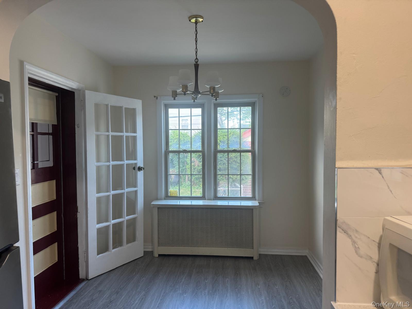 80-23 247th Street Queens, NY 11426 - Photo 9 of 19 a room with window and wooden floor