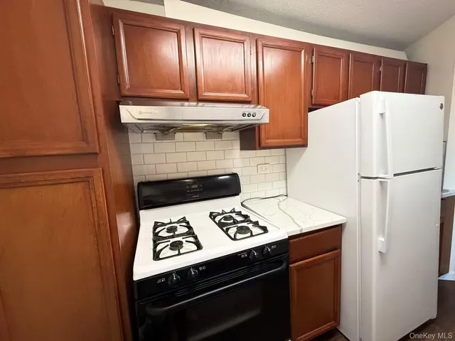 a kitchen with a stove and a refrigerator