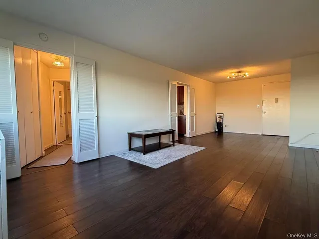 a view of a room with wooden floor and window