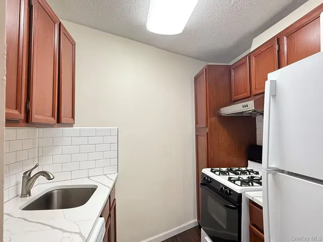 a kitchen with a sink and a refrigerator