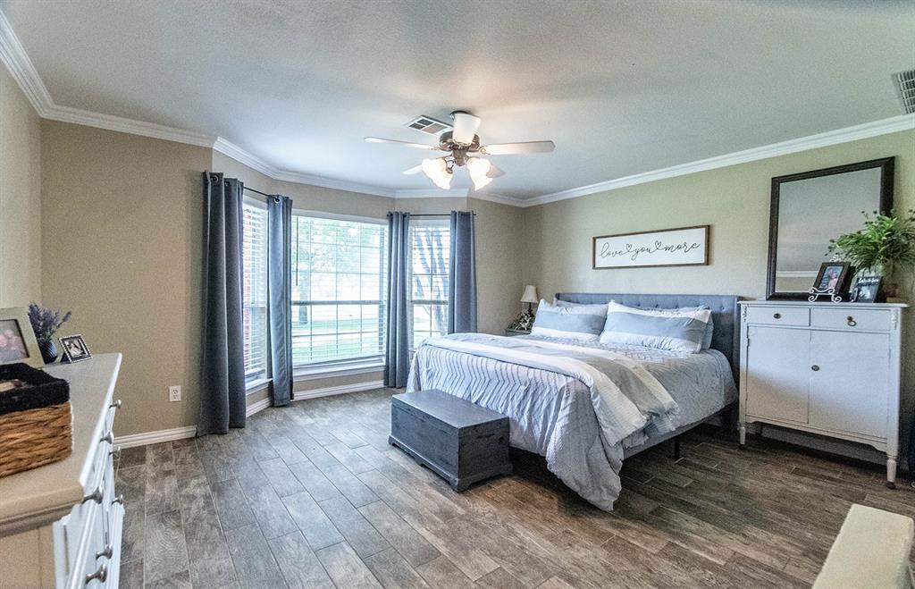 10336 Jennifer Circle Forney, TX 75126 - Photo 17 of 37 Retreat to your large, natural light filled primary suite with Grand bay Windows and Rich wood-look floors.