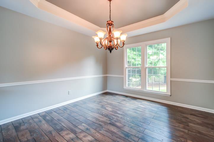 109 Chester Stevens Road Franklin, TN 37067 - Photo 7 of 30 a view of an empty room with wooden floor and a window