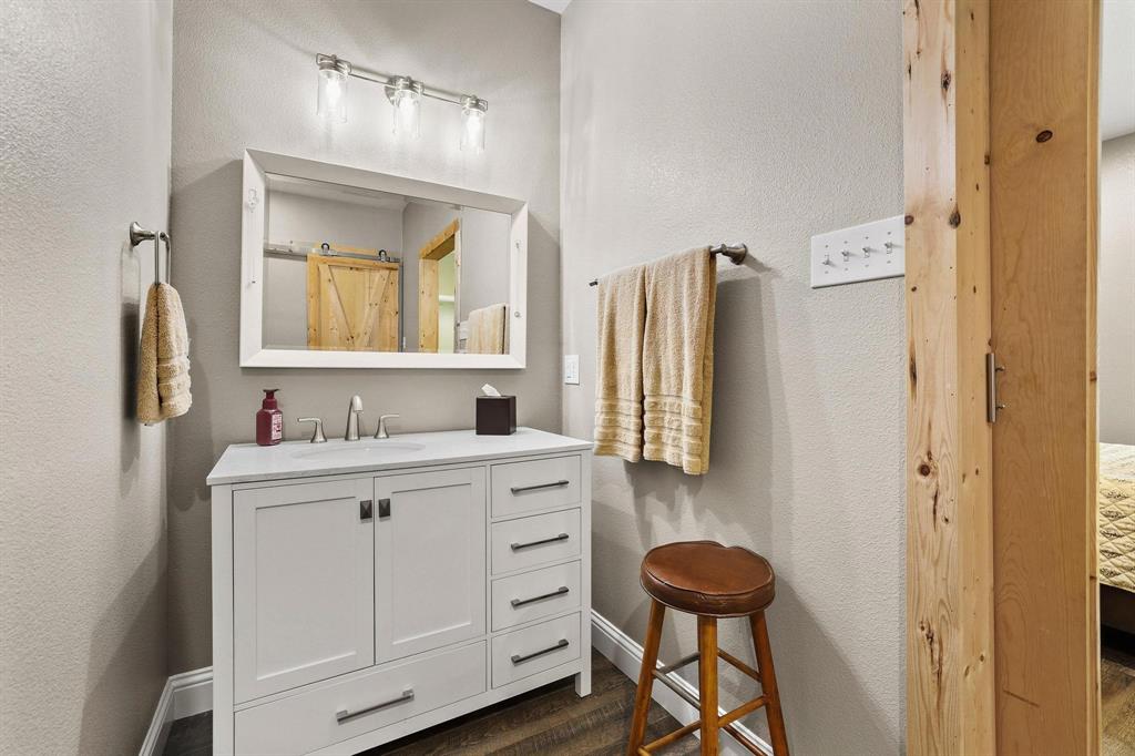 2658 Oak Ridge Road Denison, TX 75021 - Photo 20 of 37 a bathroom with a sink a toilet and a mirror