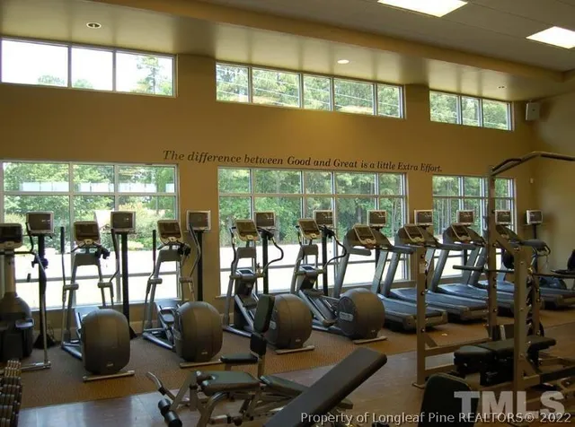 a room with gym equipment and windows