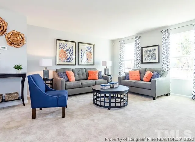 a living room with furniture and a large window