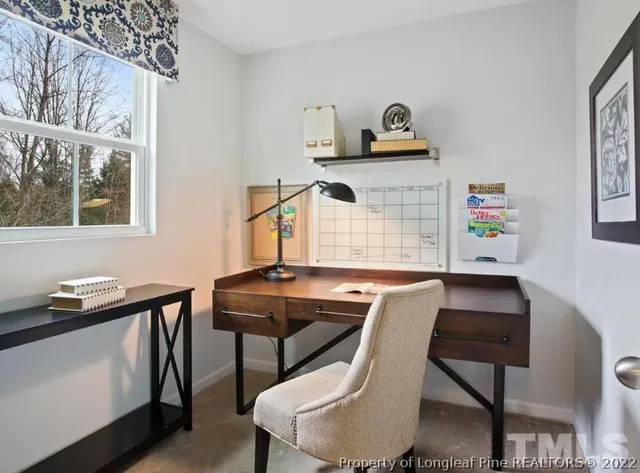 a work room with furniture and window