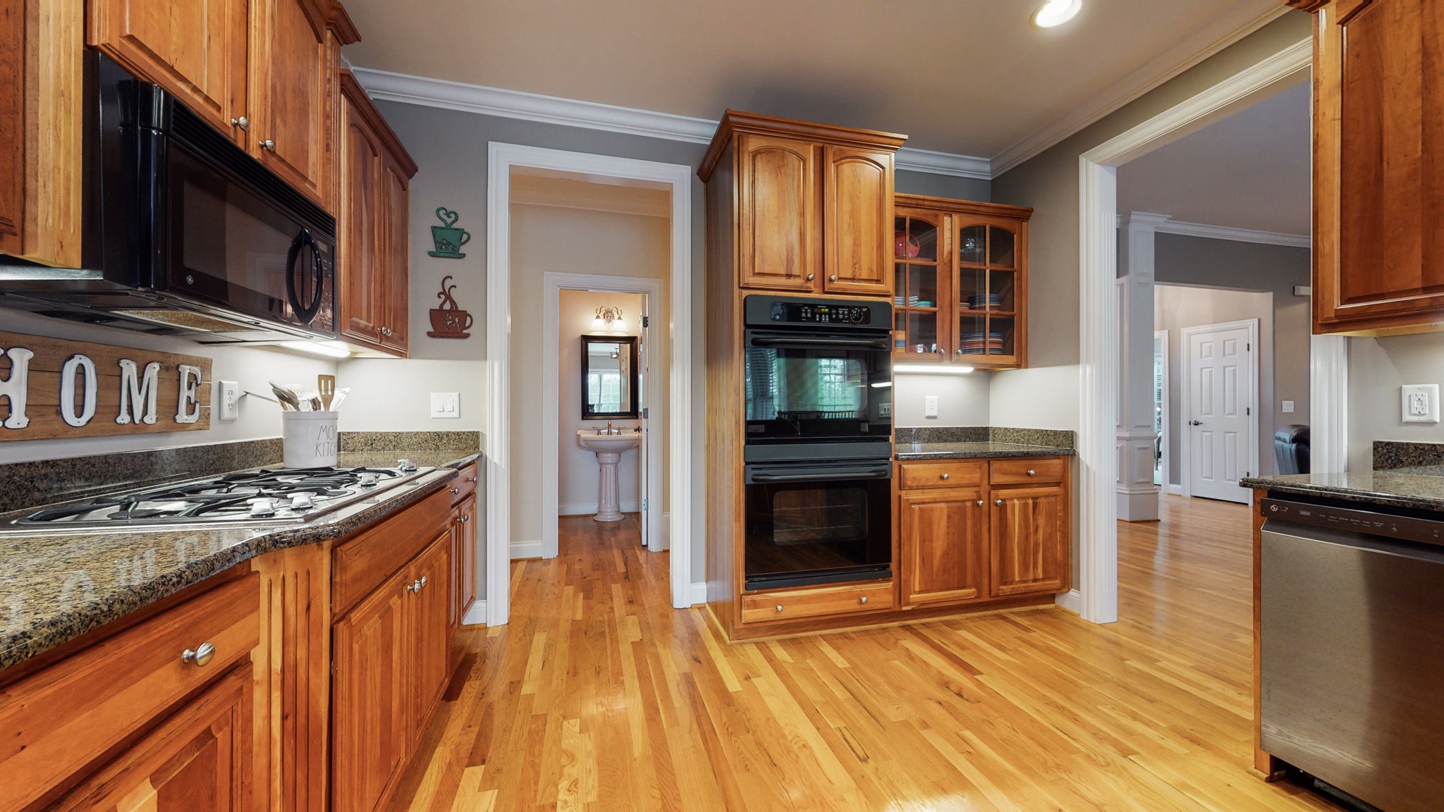 665 Springlake Drive Franklin, TN 37064 - Photo 17 of 41 a kitchen with stainless steel appliances granite countertop a stove top oven a sink dishwasher and a microwave oven with wooden floor