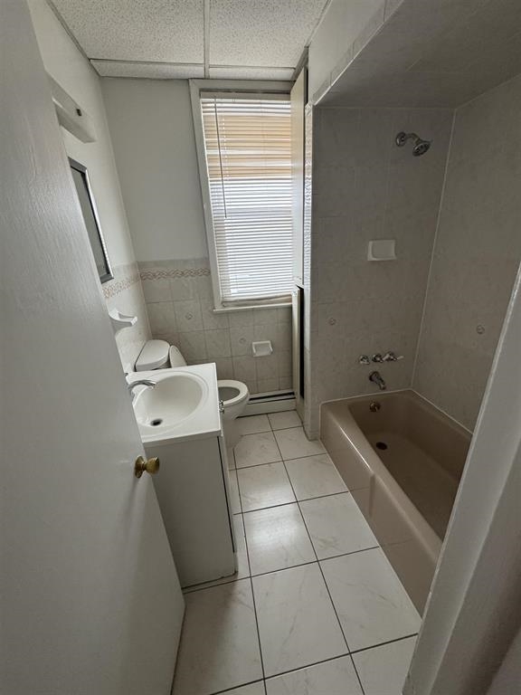 596 Adams Avenue, Unit 1 Elizabeth, NJ 07201 - Photo 11 of 11 a bathroom with a tub sink and mirror