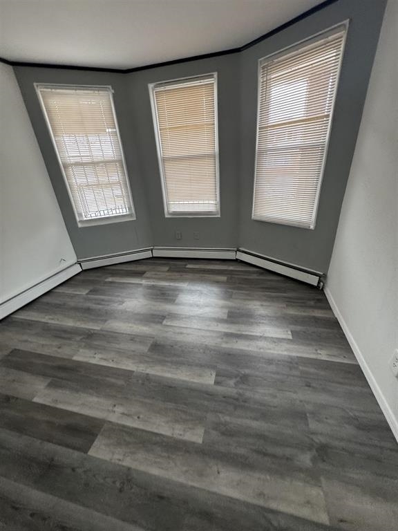 596 Adams Avenue, Unit 1 Elizabeth, NJ 07201 - Photo 3 of 11 an empty room with wooden floor and windows