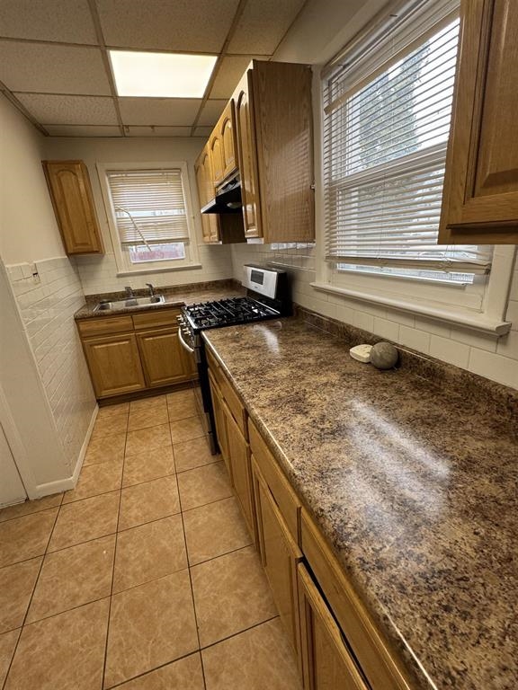 596 Adams Avenue, Unit 1 Elizabeth, NJ 07201 - Photo 5 of 11 a kitchen with kitchen island granite countertop a sink and a stove