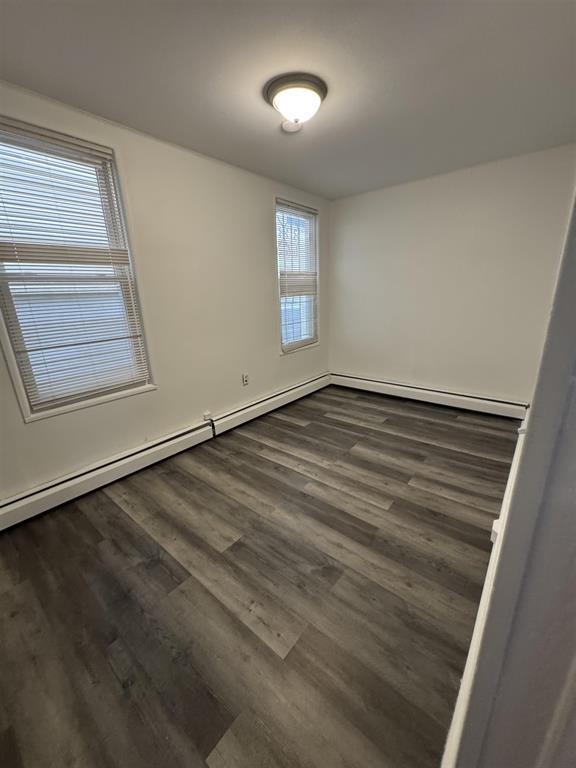 596 Adams Avenue, Unit 1 Elizabeth, NJ 07201 - Photo 10 of 11 an empty room with wooden floor and windows