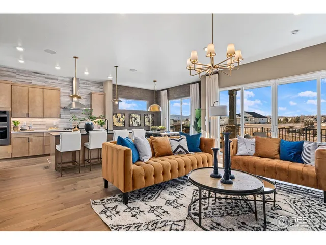 a living room with furniture kitchen and a chandelier