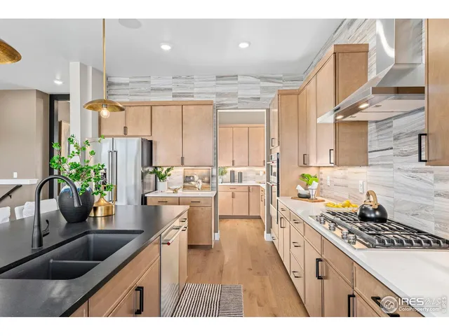 a kitchen with stainless steel appliances kitchen island granite countertop a sink stove and cabinets