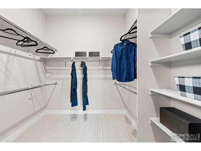 a kitchen with a refrigerator and white cabinets