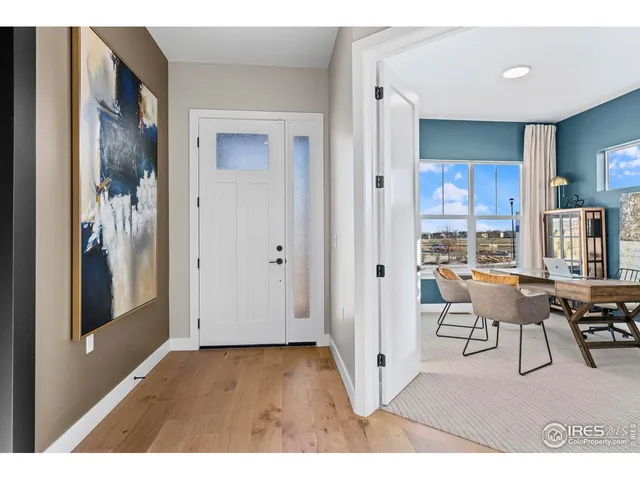 a living room with furniture a rug and kitchen view