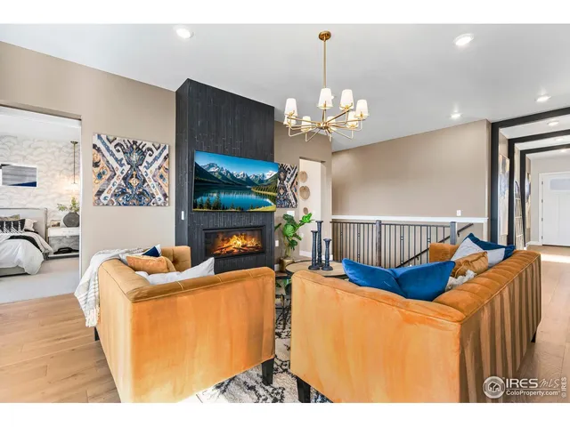 a living room with furniture and a view of kitchen