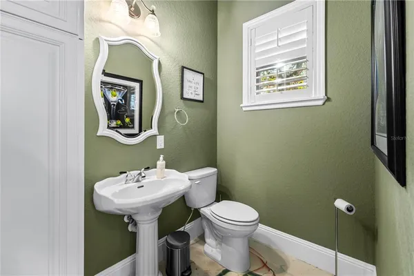 a brick house with lots of trees