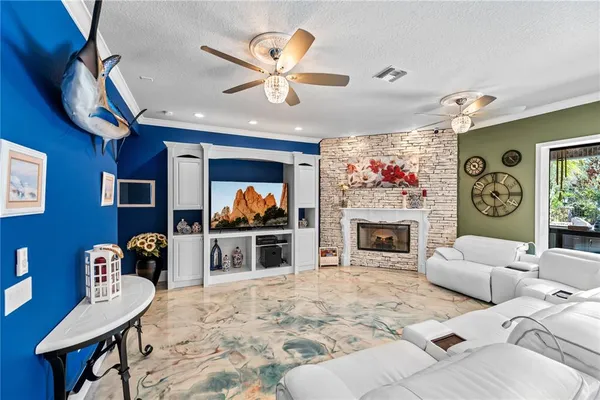 a living room with fireplace furniture and a floor to ceiling window