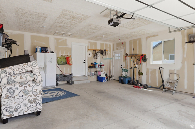 625 East 100 South Ephraim, UT 84627 - Photo 25 of 26 Spacious two-car garage featuring a concrete floor, an overhead garage door with opener, a single window, and two interior access doors