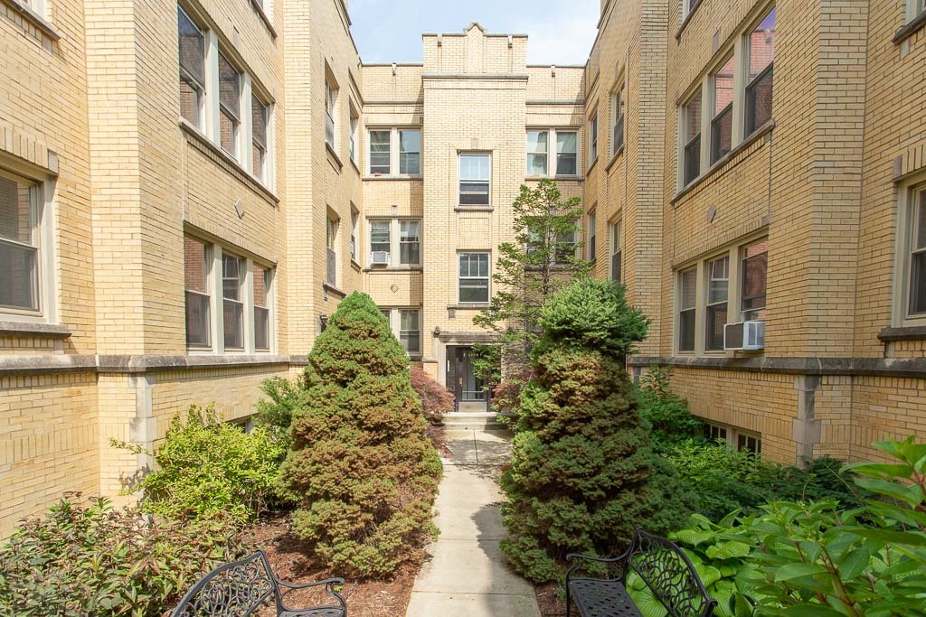 a view of a building with a lot of flower plants