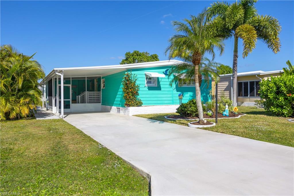 front view of house with a yard and potted plants