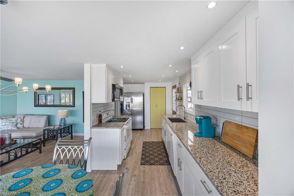 216 Rookery Road Naples, FL 34114 - Photo 14 of 44 a living room with furniture and a couch